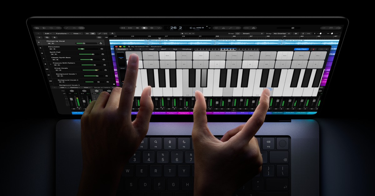 Apple’s promotional image shows fingers using musical controls on the touchscreen MacBook Pro.