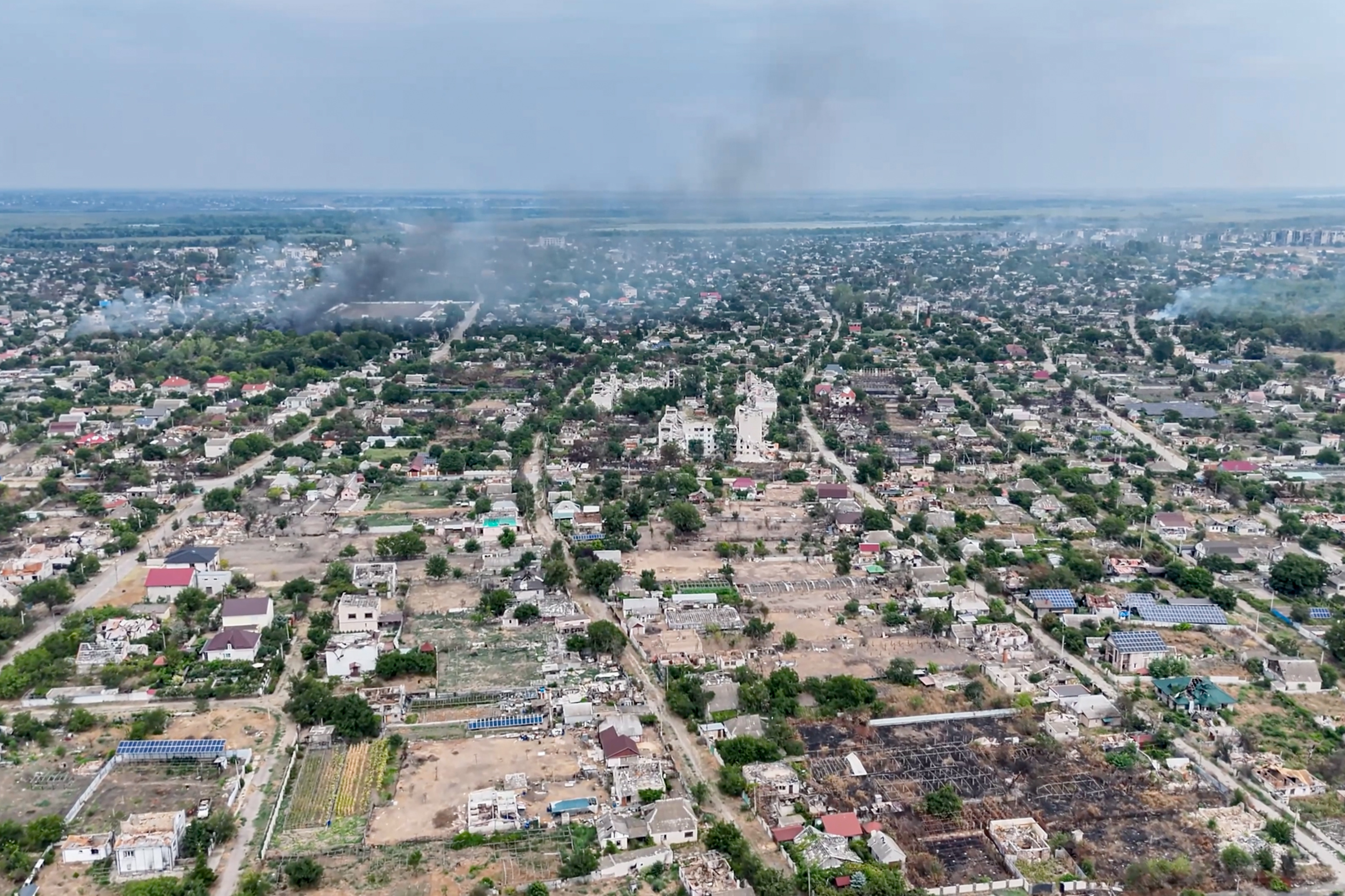 Aerial view of the damaged city in the AP article.