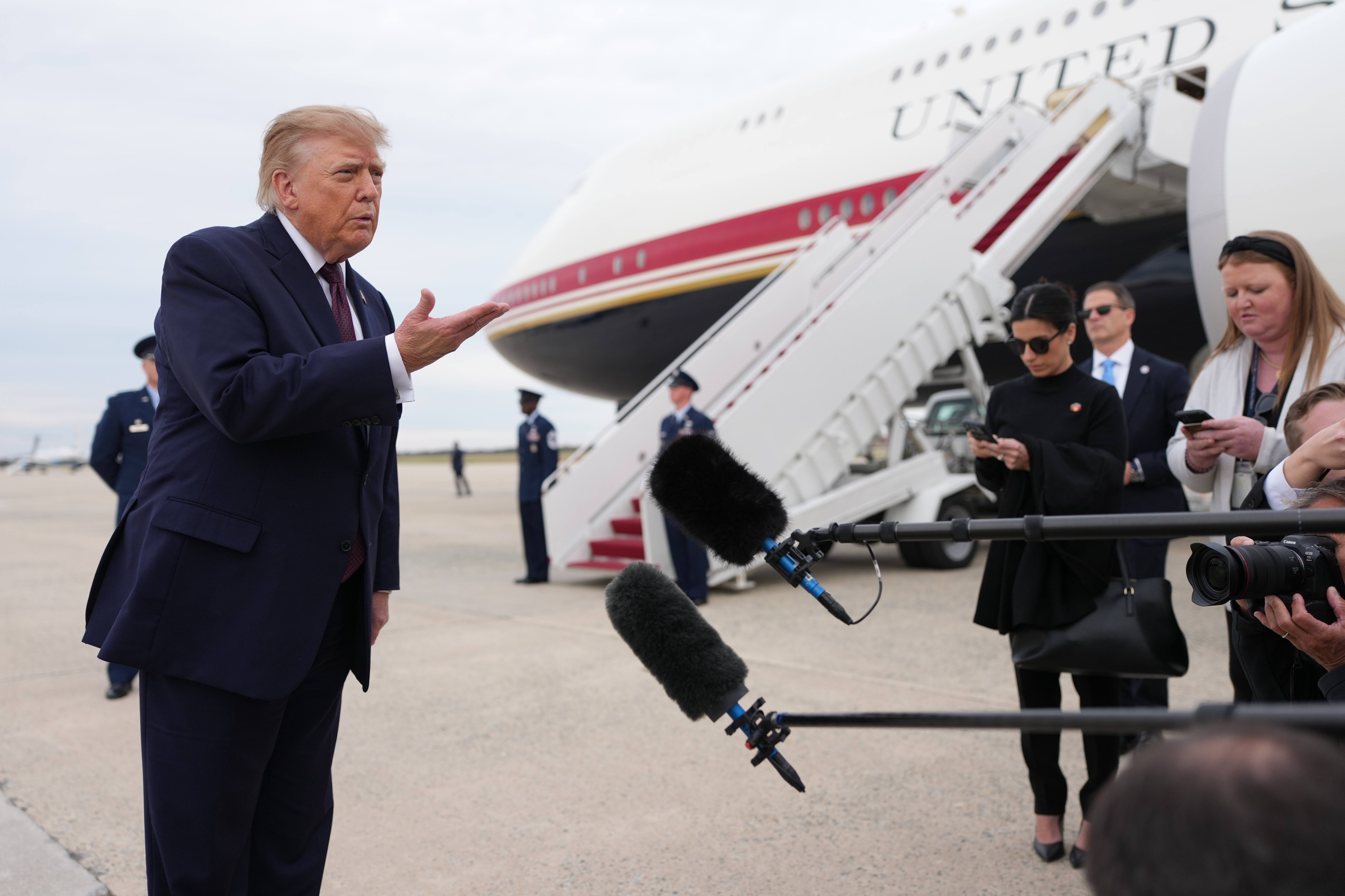 Donald Trump speaks with reporters beside Air Force One at Joint Base Andrews.