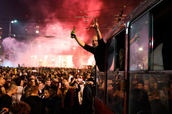 People celebrate in Belgrade after Serbia’s parliamentary election.